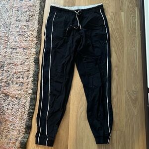 Athleta sweatpants joggers in black with white stripe. Size 6.
